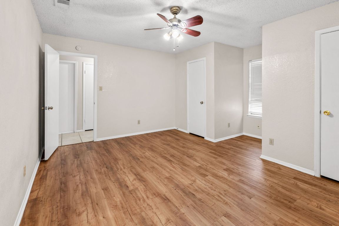 818 Sirocco Drive, Unit B Austin, TX 78745 - Photo 19 of 34 a view of a big room with wooden floor and a chandelier fan