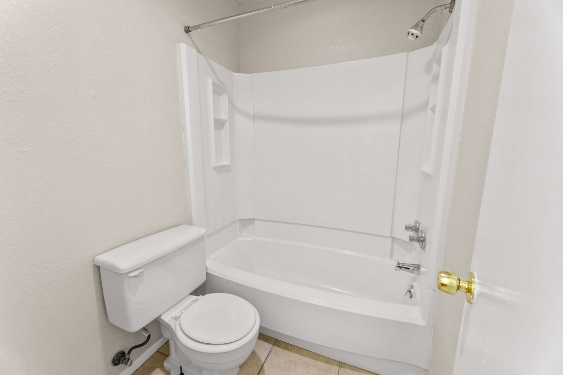 818 Sirocco Drive, Unit B Austin, TX 78745 - Photo 26 of 34 a white toilet and tub sitting next to a white cabinet