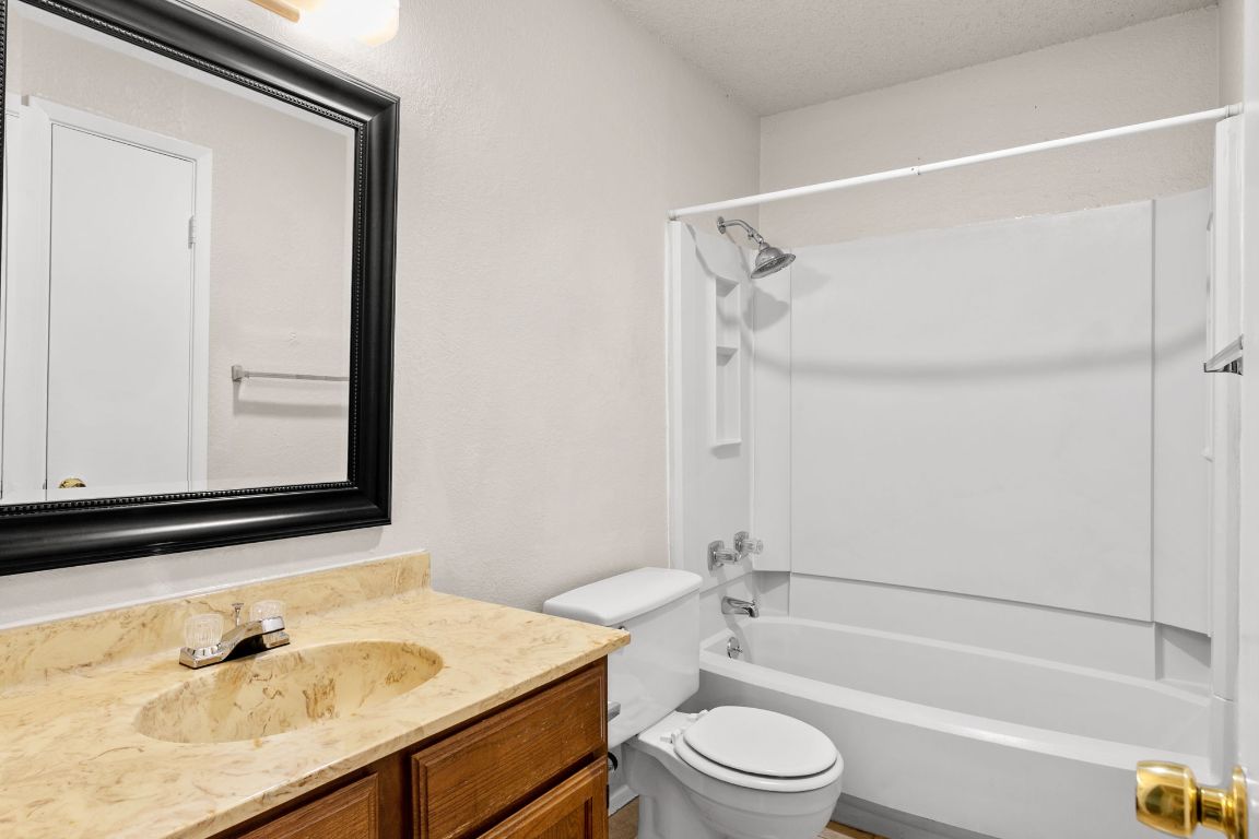 818 Sirocco Drive, Unit B Austin, TX 78745 - Photo 27 of 34 a bathroom with a sink and a mirror