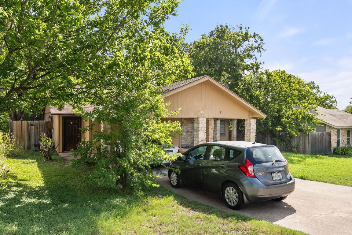 818 Sirocco Drive, Unit B Austin, TX 78745 - Photo 4 of 34 a car parked in front of a house with a small yard