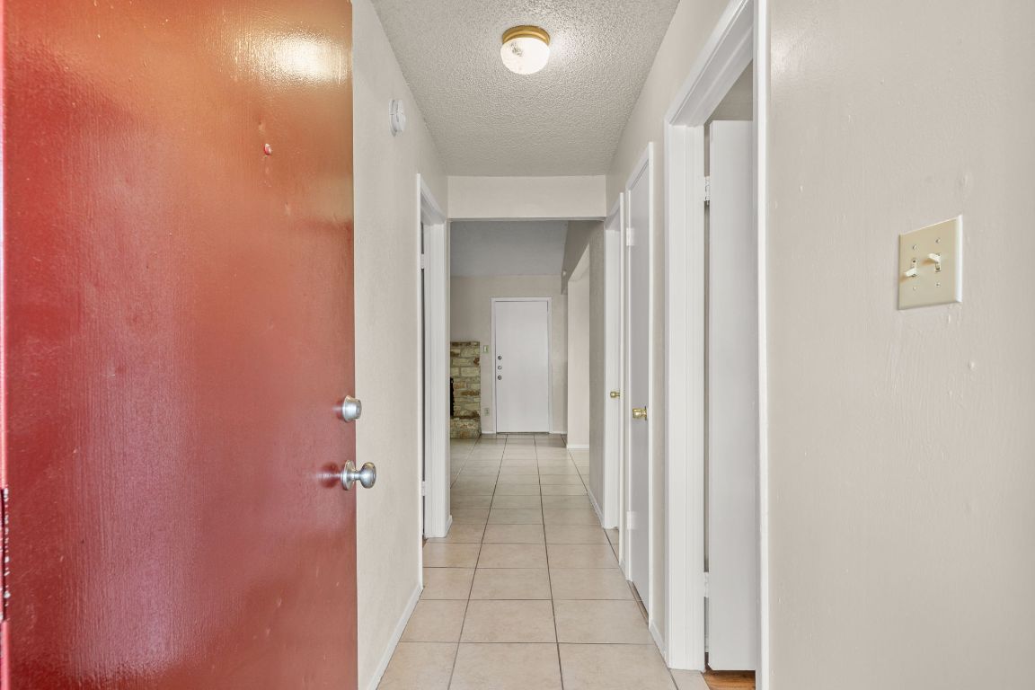 818 Sirocco Drive, Unit B Austin, TX 78745 - Photo 5 of 34 a view of a hallway with wooden shelves