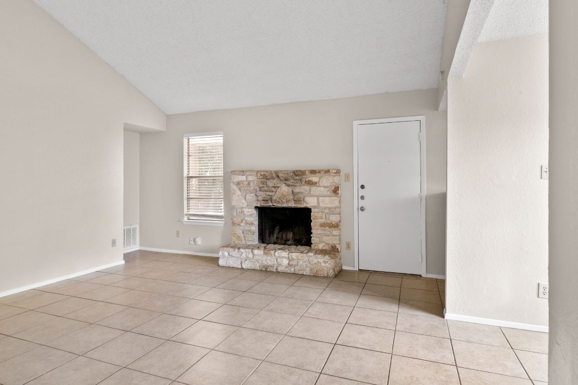 818 Sirocco Drive, Unit B Austin, TX 78745 - Photo 7 of 34 a view of an empty room with a fireplace