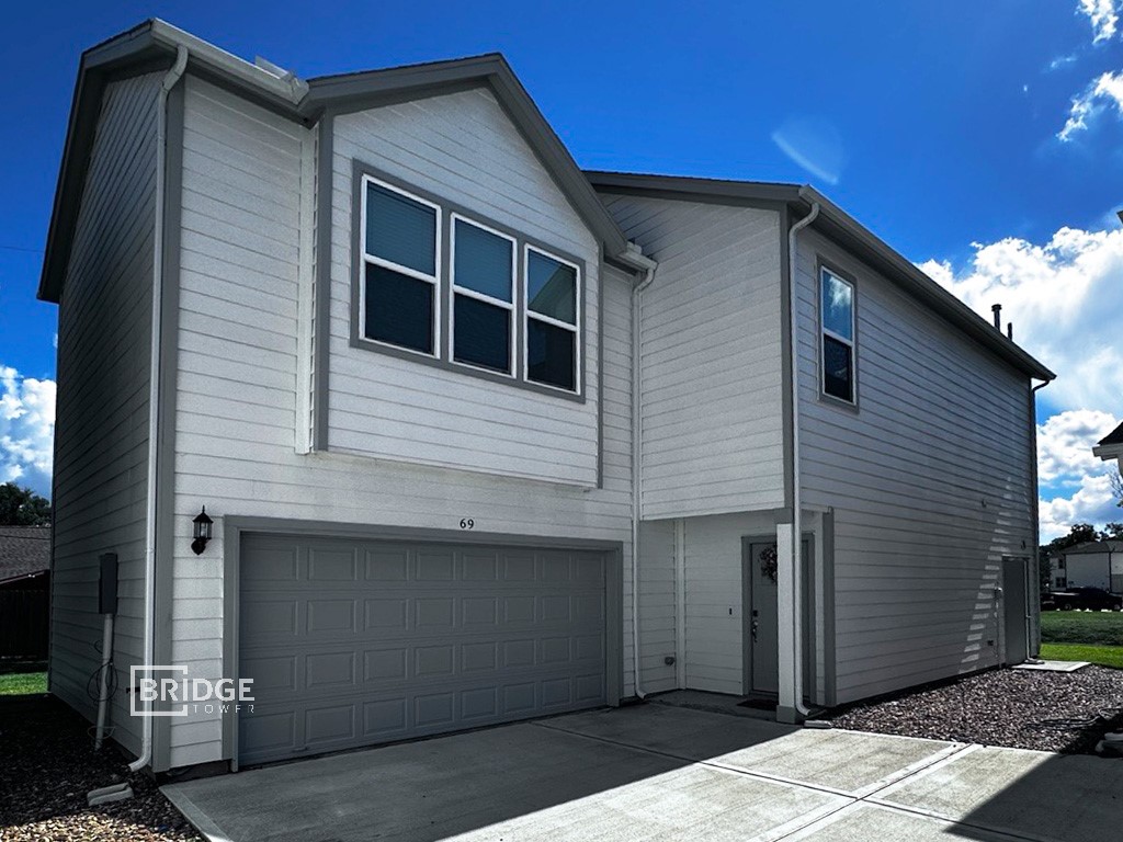 a front view of a house with a garage