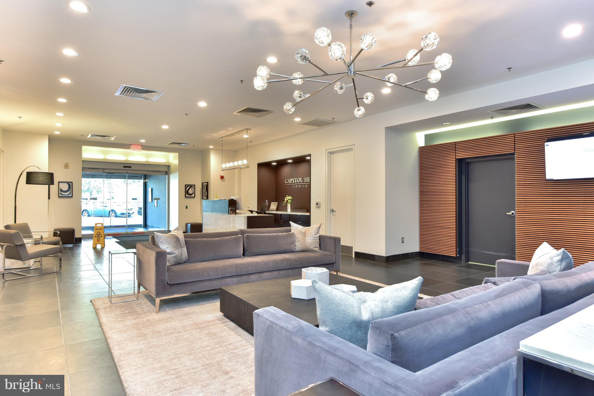 1000 New Jersey Avenue Southeast, Unit 108 Washington, DC 20003 - Photo 13 of 21 a living room with fireplace furniture and a chandelier