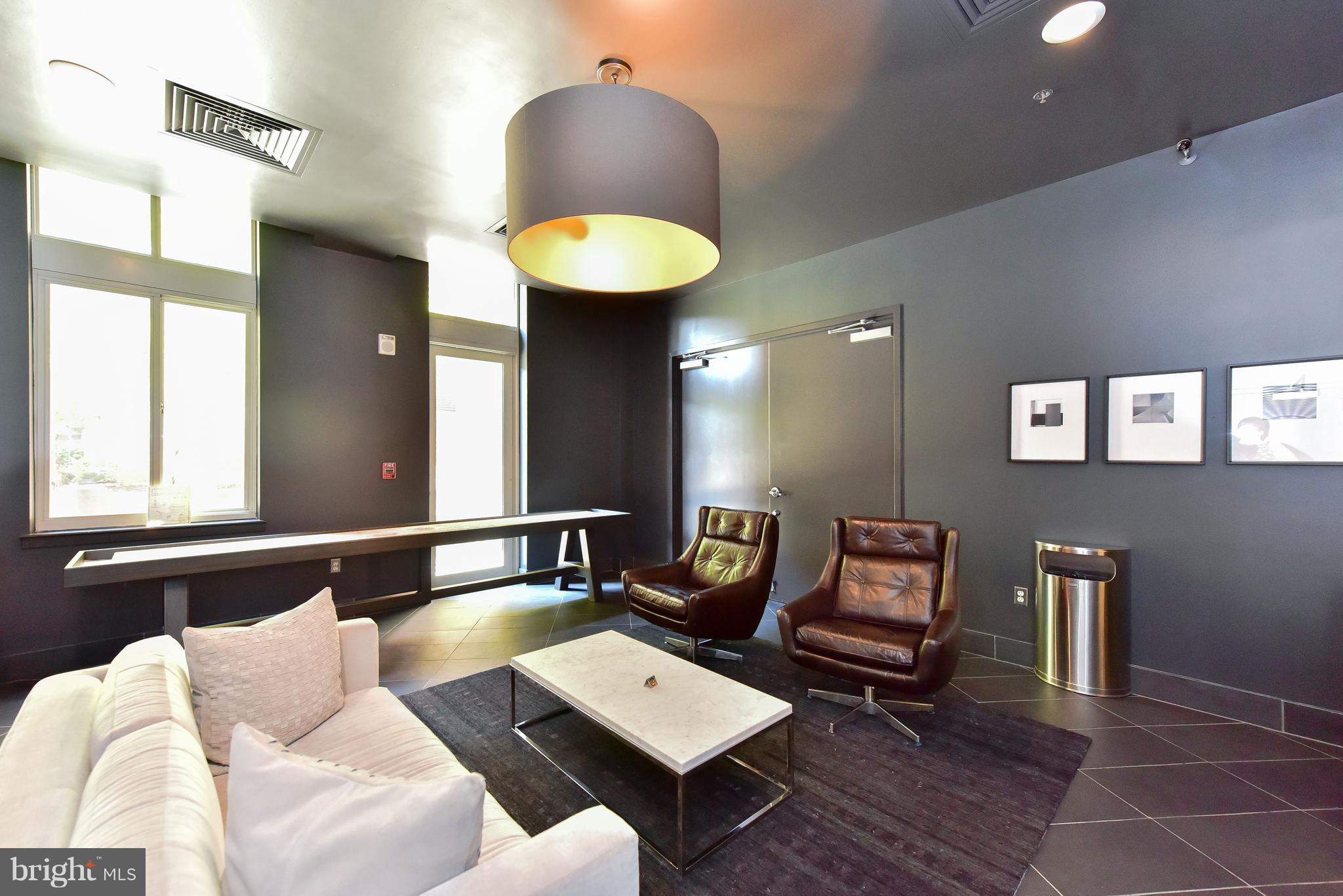 1000 New Jersey Avenue Southeast, Unit 108 Washington, DC 20003 - Photo 14 of 21 a living room with furniture and a wooden floor