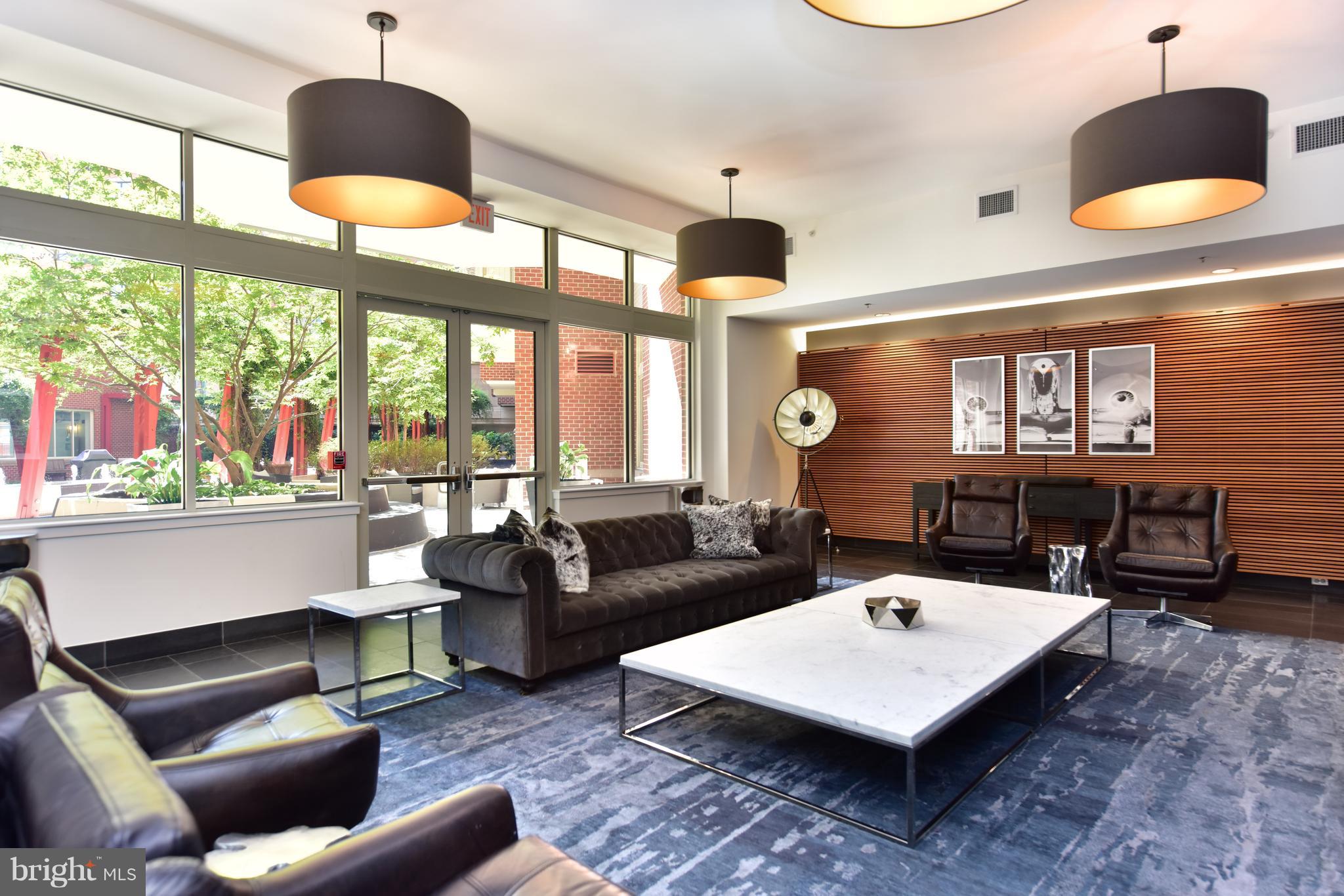 1000 New Jersey Avenue Southeast, Unit 108 Washington, DC 20003 - Photo 17 of 21 a living room with furniture and a large window
