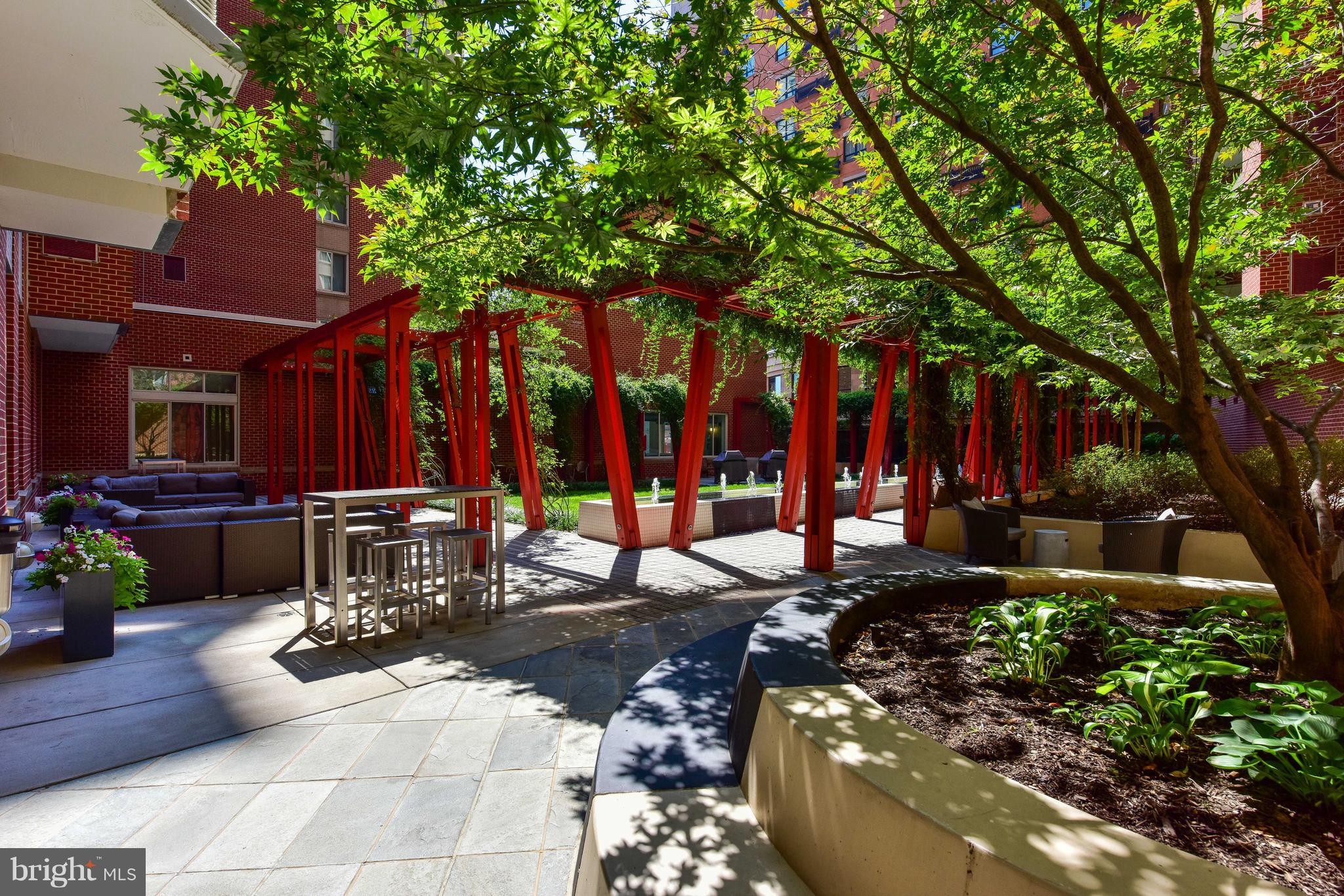 1000 New Jersey Avenue Southeast, Unit 108 Washington, DC 20003 - Photo 18 of 21 a view of a patio with table and chairs and potted plants