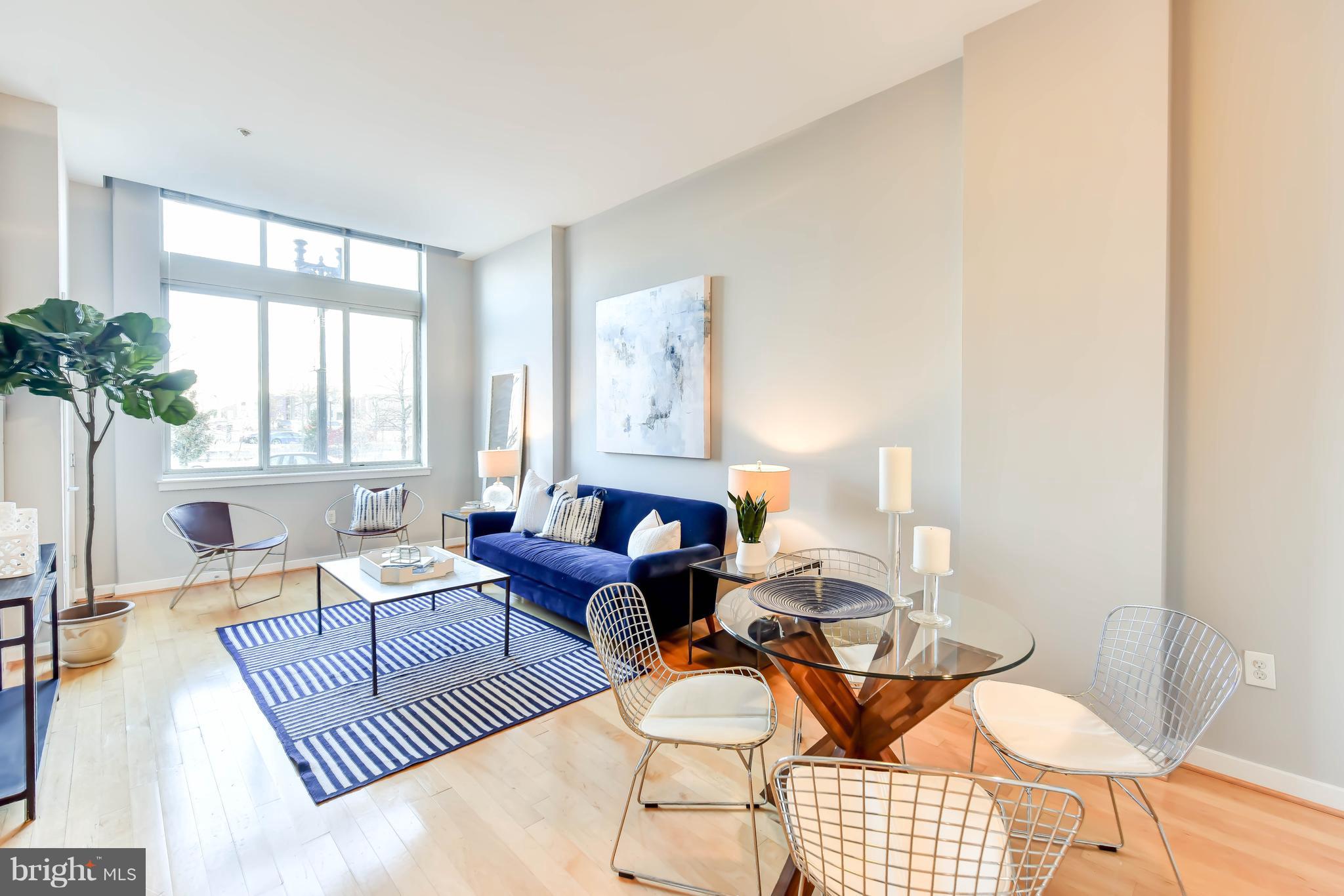 1000 New Jersey Avenue Southeast, Unit 108 Washington, DC 20003 - Photo 3 of 21 a living room with furniture and a large window