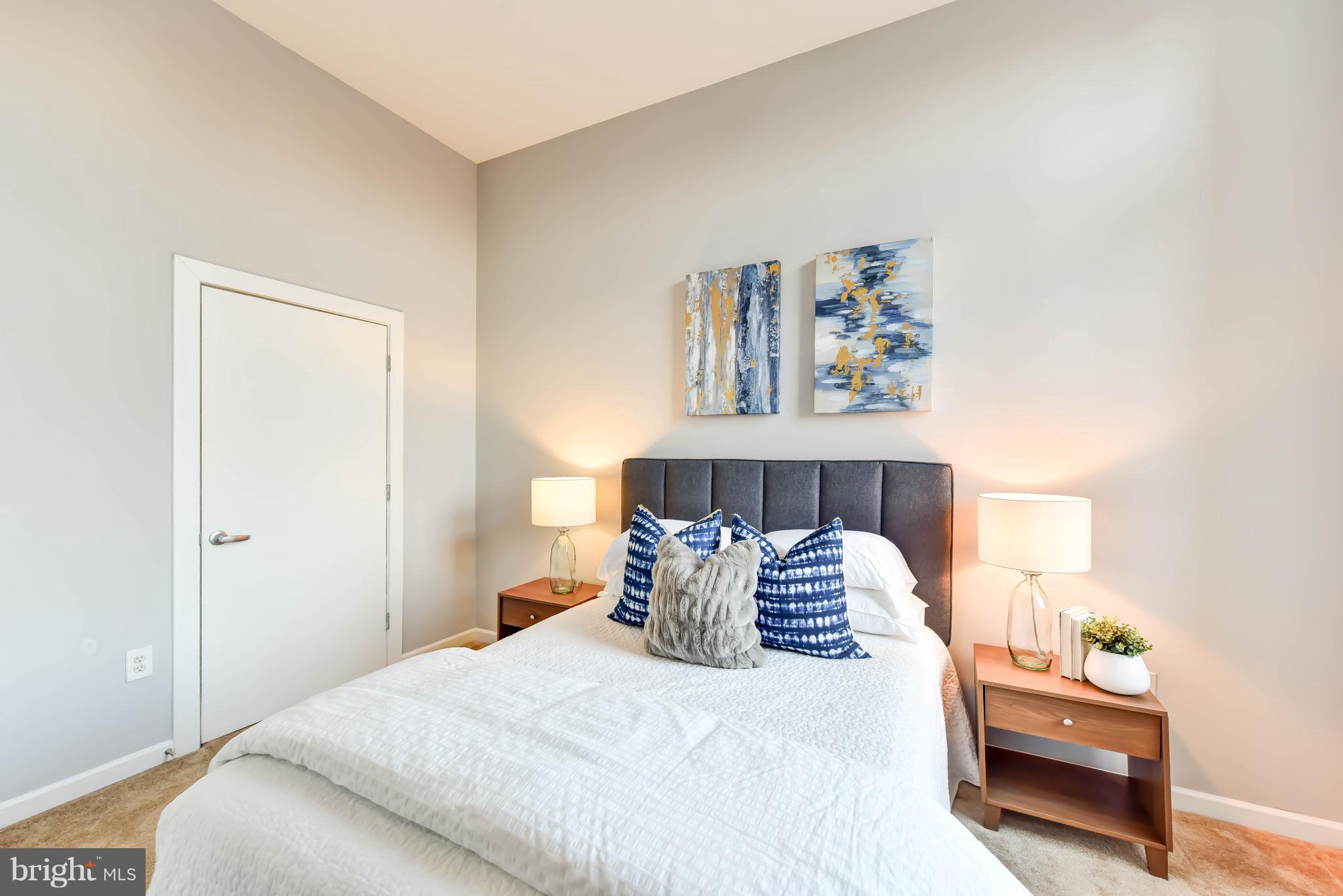 1000 New Jersey Avenue Southeast, Unit 108 Washington, DC 20003 - Photo 7 of 21 a bedroom with a bed and a painting on the wall