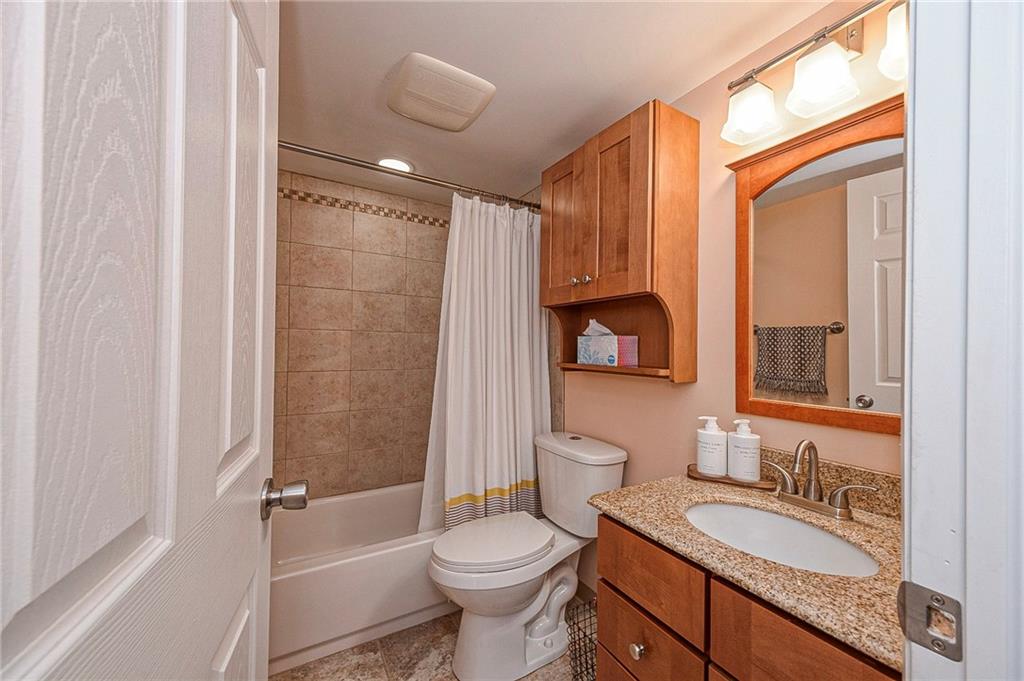 5 Bayard Road, Unit 621 Pittsburgh, PA 15213 - Photo 15 of 38 a bathroom with a granite countertop toilet sink and mirror