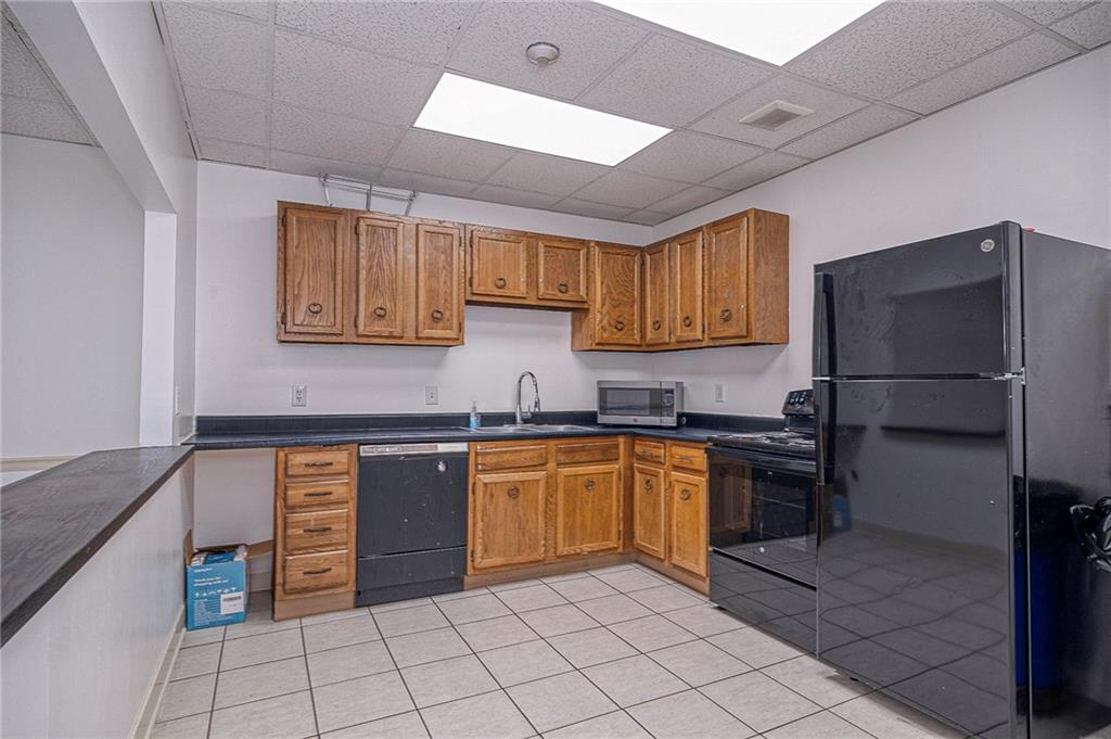 5 Bayard Road, Unit 621 Pittsburgh, PA 15213 - Photo 24 of 38 a kitchen with stainless steel appliances granite countertop a refrigerator and a stove top oven