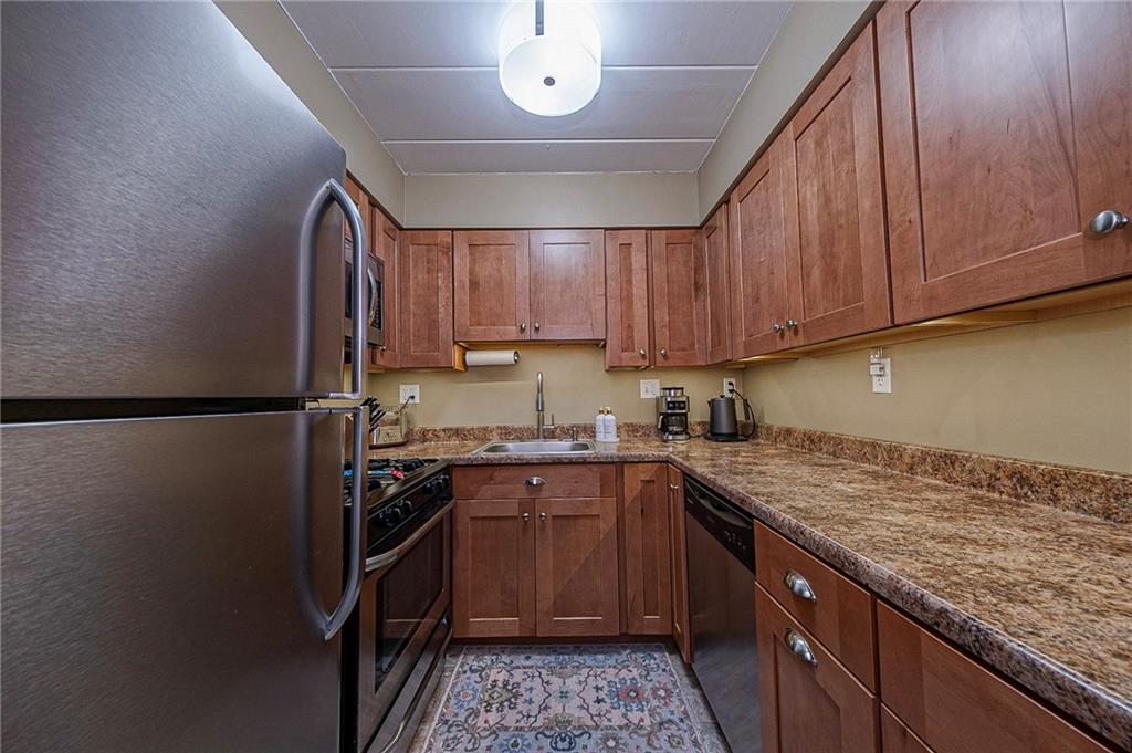 5 Bayard Road, Unit 621 Pittsburgh, PA 15213 - Photo 7 of 38 a kitchen with stainless steel appliances granite countertop a sink stove and refrigerator