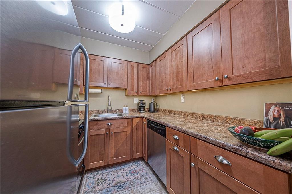5 Bayard Road, Unit 621 Pittsburgh, PA 15213 - Photo 8 of 38 a kitchen with stainless steel appliances granite countertop a sink stove and refrigerator