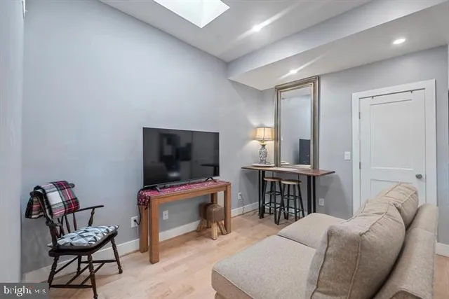 a bedroom with furniture and a flat screen tv