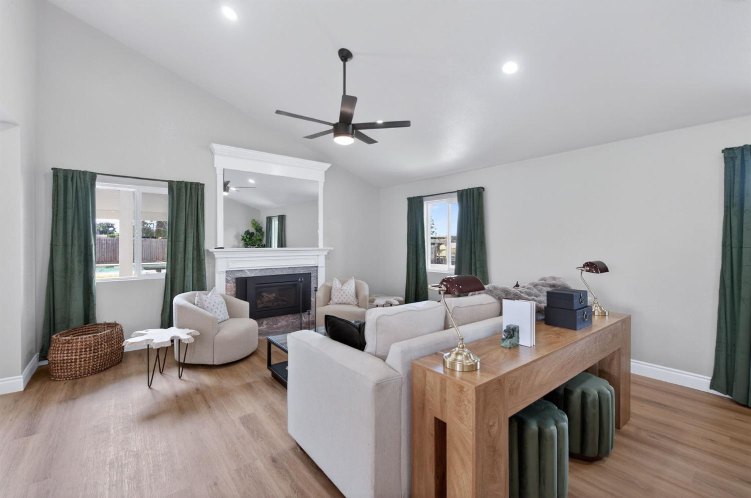 16564 Monreal Road Madera, CA 93636 - Photo 9 of 59 a living room with furniture and a chandelier