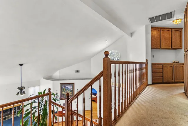 a view of a hallway with stairs