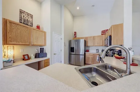 a kitchen with refrigerator and washing machine