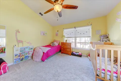 a bedroom with furniture and a large window