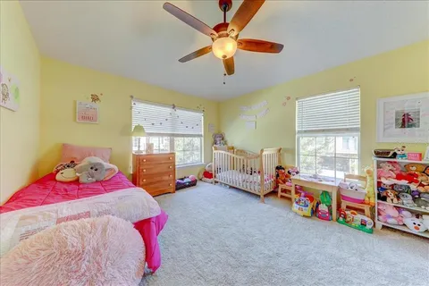 a bedroom with bed and window