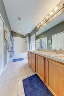 a spacious bathroom with a tub and shower