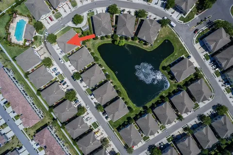 an aerial view of a house with a yard and outdoor seating