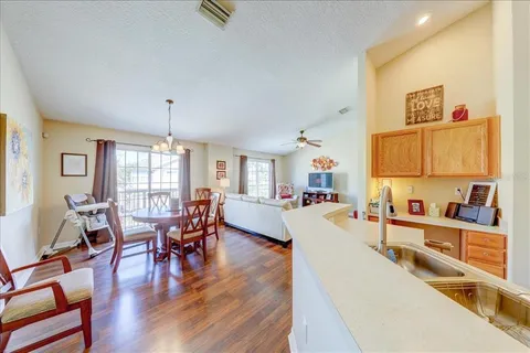a living room with furniture wooden floor and a chandelier