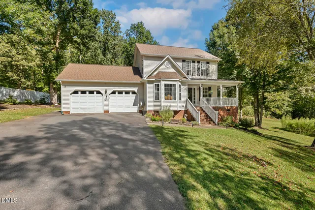 a view of a house with backyard porch and sitting area