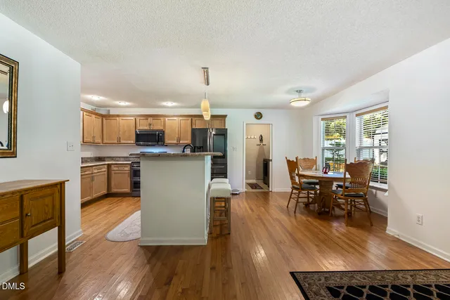 a view of a dining room with furniture and wooden floor