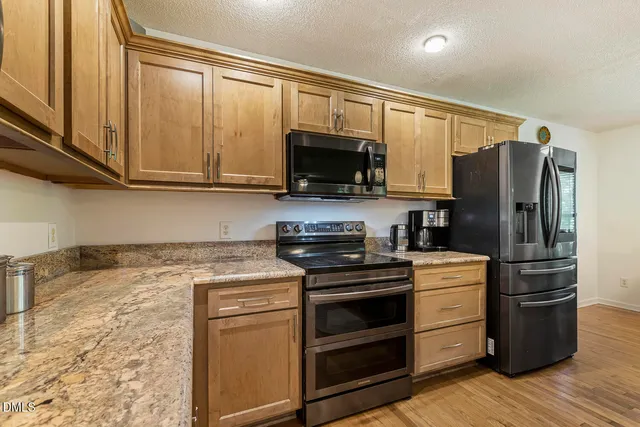 a kitchen with a stove and a microwave