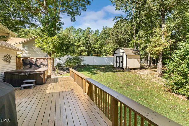 a view of a house with a big yard and large trees