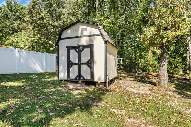 an aerial view of a house with a yard basket ball court and outdoor seating