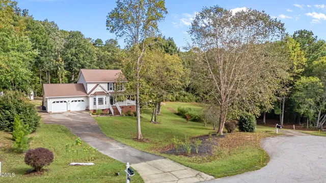 an aerial view of a house with pool yard and outdoor seating