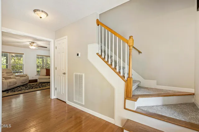 a view of entryway and hall with wooden floor