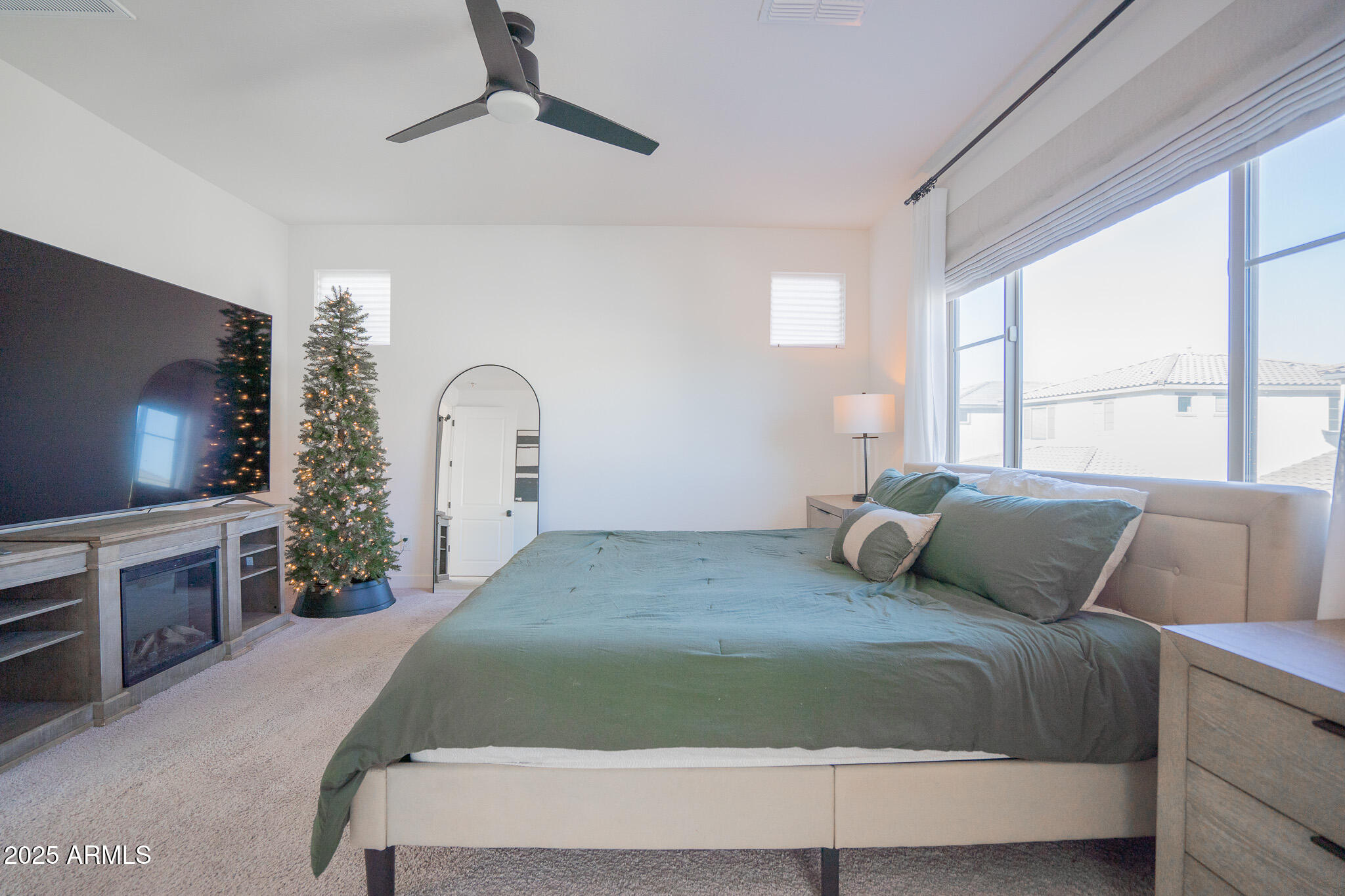 10050 East Tiburon Avenue Mesa, AZ 85212 - Photo 22 of 47 a bedroom with a large bed and a flat tv screen on dresser