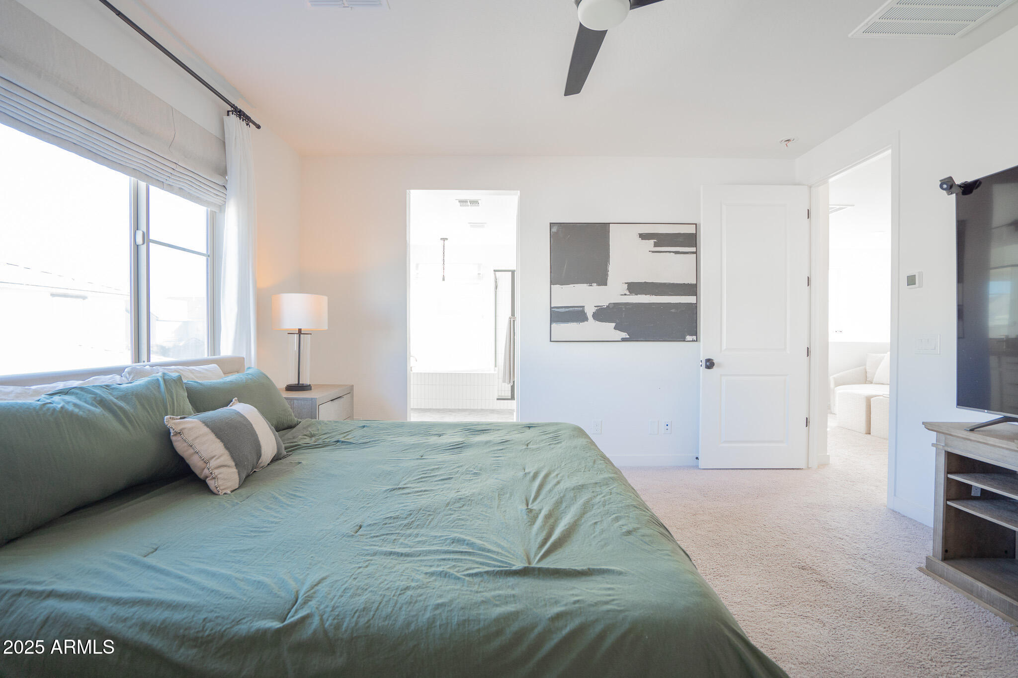 10050 East Tiburon Avenue Mesa, AZ 85212 - Photo 23 of 47 a spacious bedroom with a bed and a couch