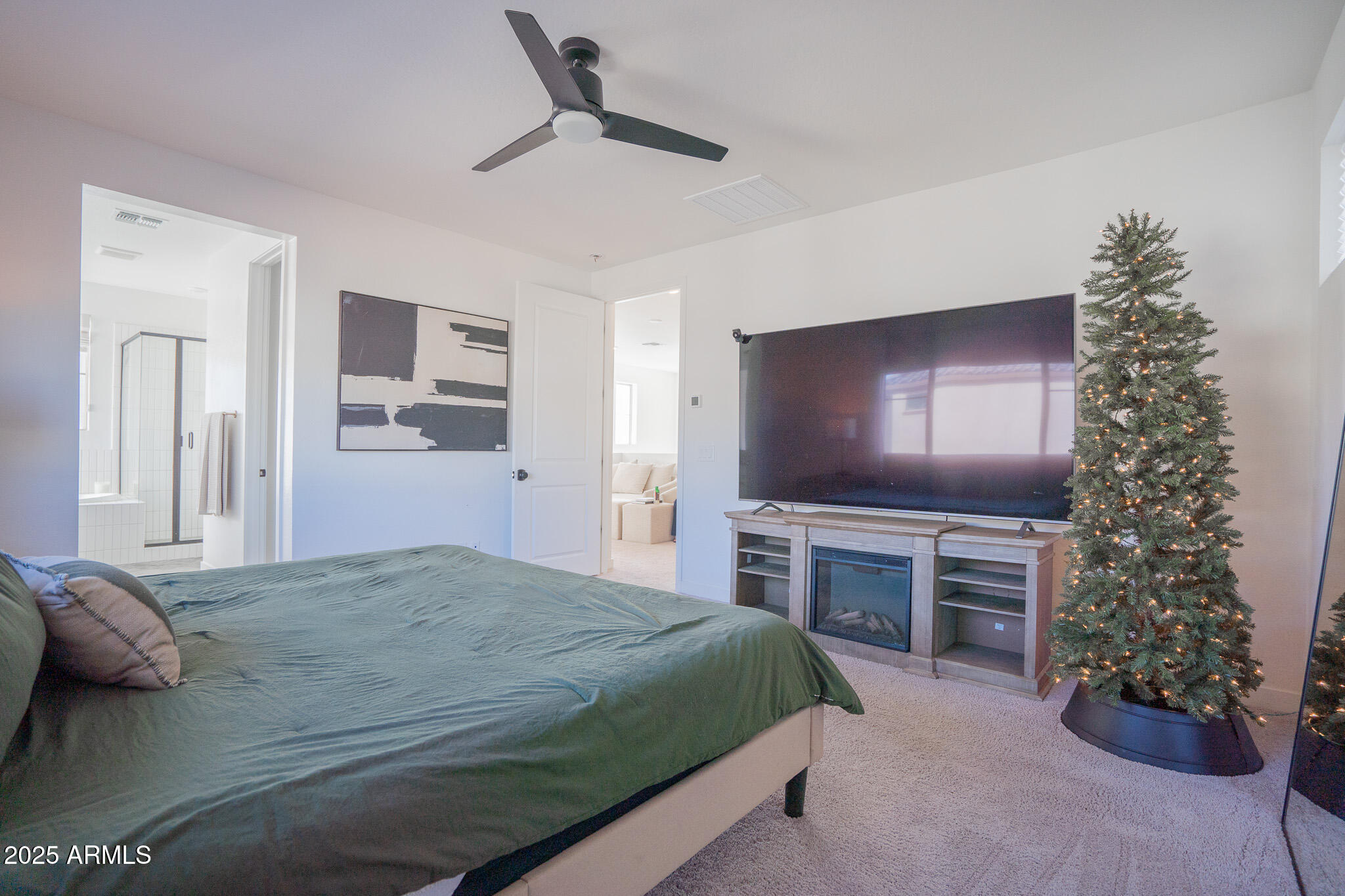 10050 East Tiburon Avenue Mesa, AZ 85212 - Photo 24 of 47 a spacious bedroom with a bed and a flat screen tv