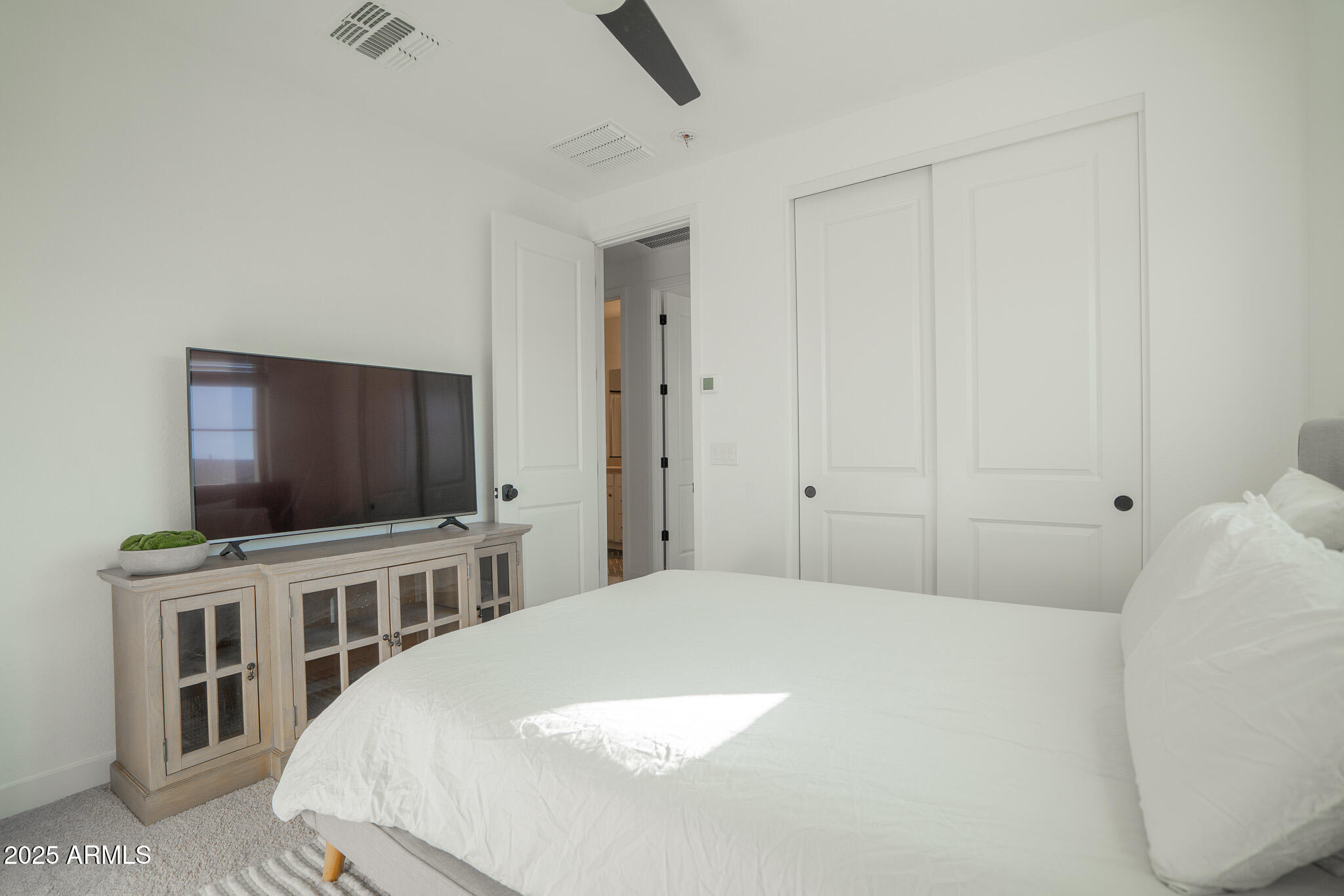 10050 East Tiburon Avenue Mesa, AZ 85212 - Photo 35 of 47 a bedroom with a bed and a flat screen tv