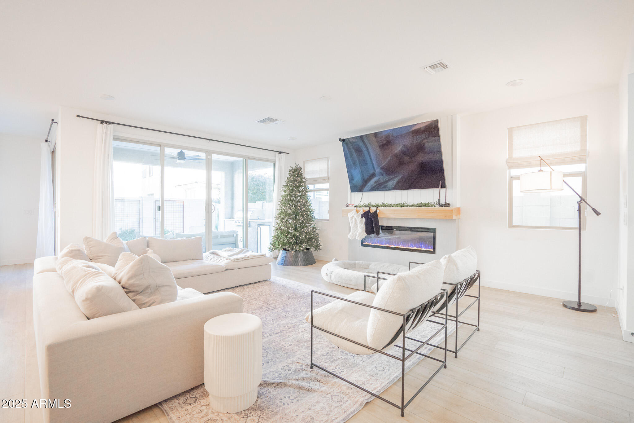 10050 East Tiburon Avenue Mesa, AZ 85212 - Photo 5 of 47 a living room with furniture a fireplace and a flat screen tv