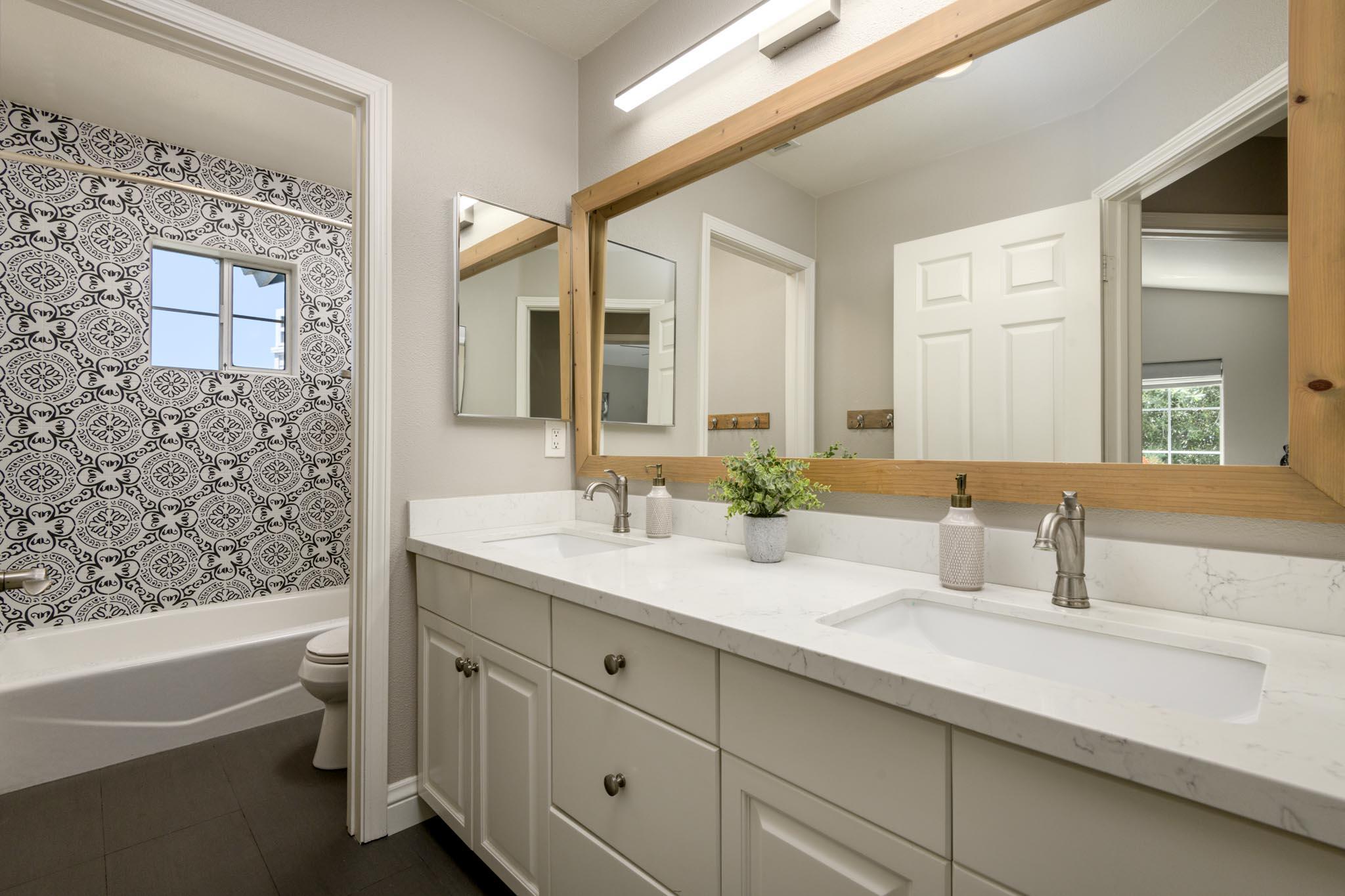 200 Oak View Lane Santa Barbara, CA 93111 - Photo 21 of 35 a bathroom with a granite countertop sink mirror and a bathtub