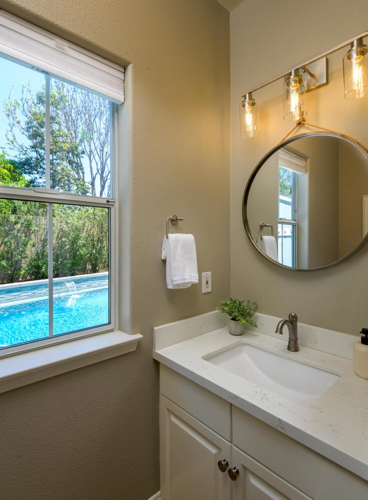 200 Oak View Lane Santa Barbara, CA 93111 - Photo 23 of 35 a bathroom with a granite countertop sink and a mirror