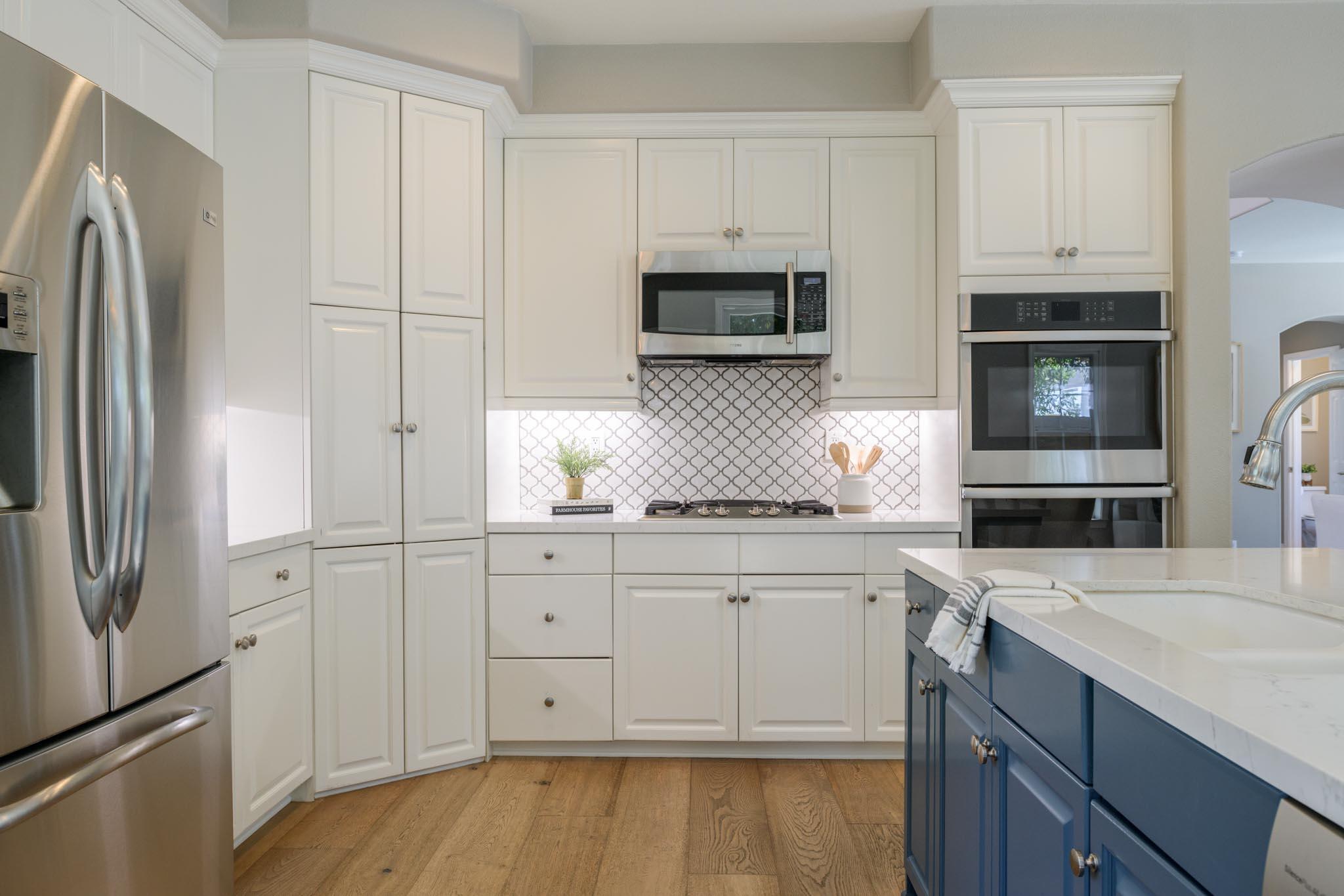 200 Oak View Lane Santa Barbara, CA 93111 - Photo 10 of 35 a kitchen with stainless steel appliances white cabinets and a refrigerator