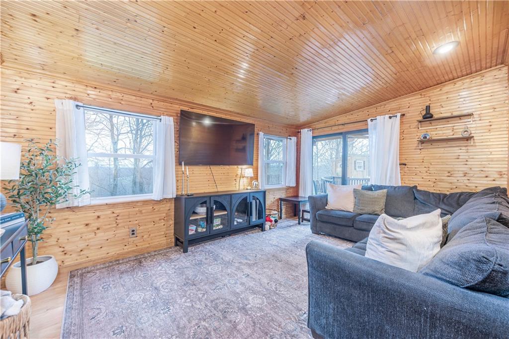 320 Deerfield Road Washington, PA 15301 - Photo 4 of 32 Cozy living room with knotty pine walls and ceiling. An abundance of natural light in this room that overlooks the woods.