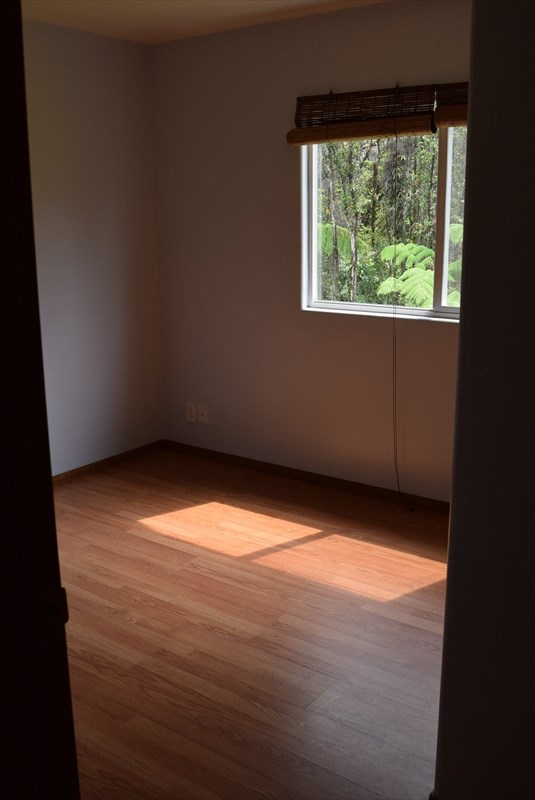 11-2855 Kaleponi Road Mountain View, HI 96771 - Photo 13 of 19 a view of empty room with wooden floor and fan