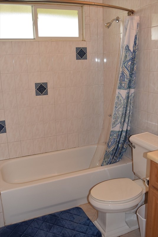 11-2855 Kaleponi Road Mountain View, HI 96771 - Photo 14 of 19 a white toilet sitting next to a bath tub and a shower