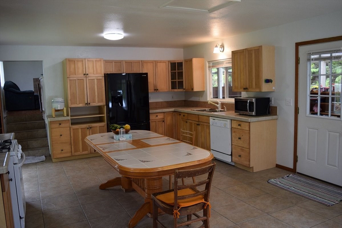 11-2855 Kaleponi Road Mountain View, HI 96771 - Photo 3 of 19 a kitchen with a sink refrigerator and cabinets