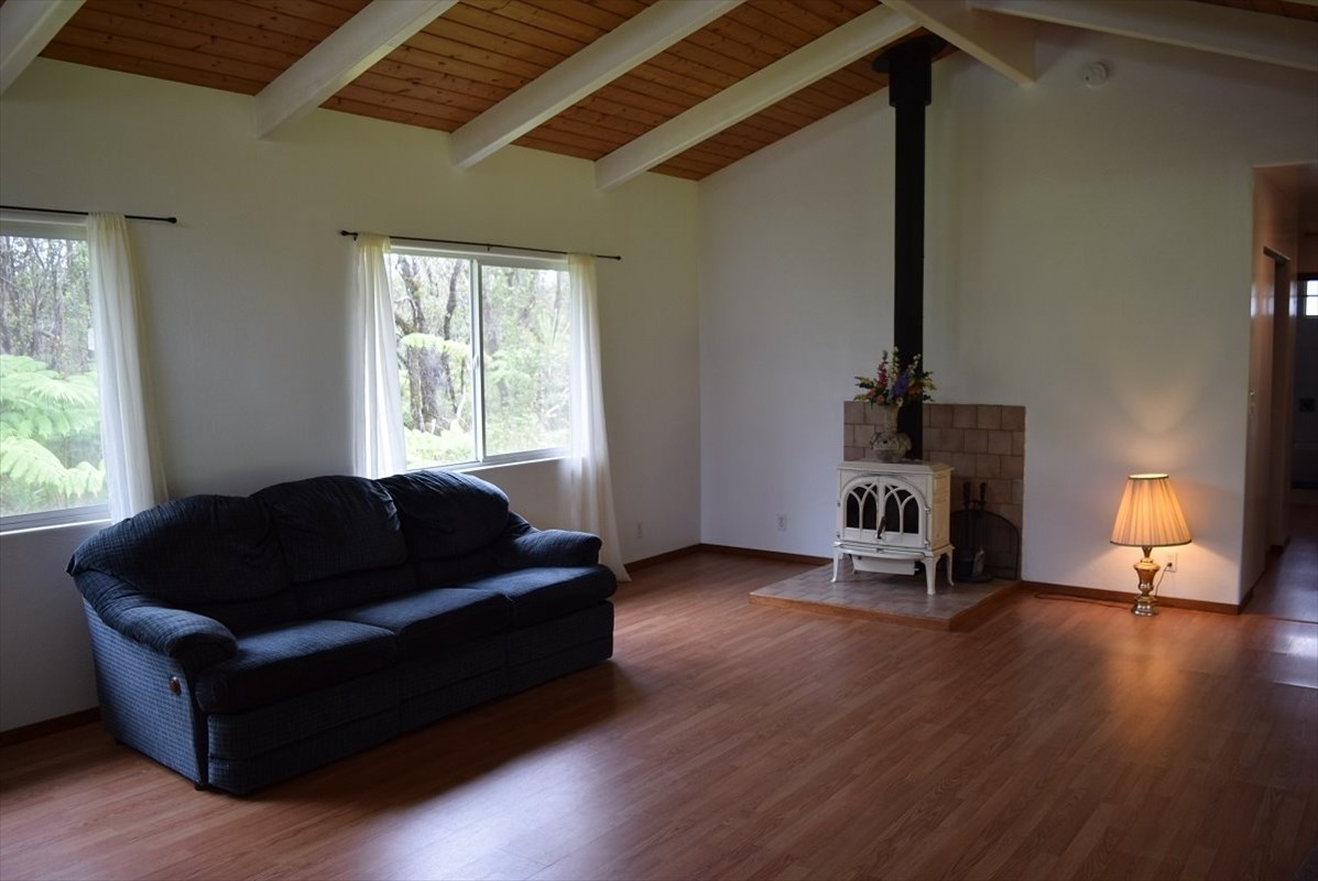 11-2855 Kaleponi Road Mountain View, HI 96771 - Photo 7 of 19 a living room with furniture and a fireplace