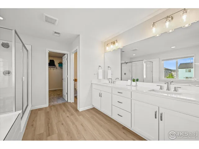 a bathroom with a double vanity sink and mirror