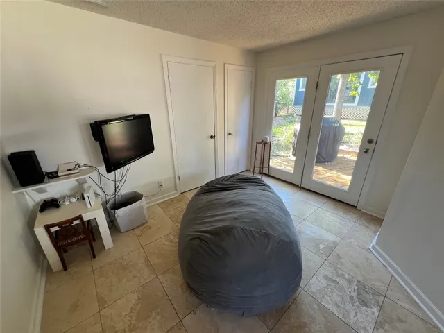 a view of a livingroom with workspace and a window