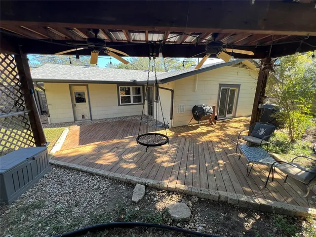 a view of a house with backyard and sitting area