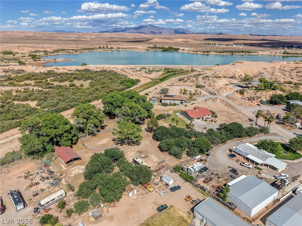 1950 Bowman Road Logandale, NV 89021 - Photo 75 of 81 An aerial perspective reveals a private rural estate set against a serene reservoir and distant mountains.
